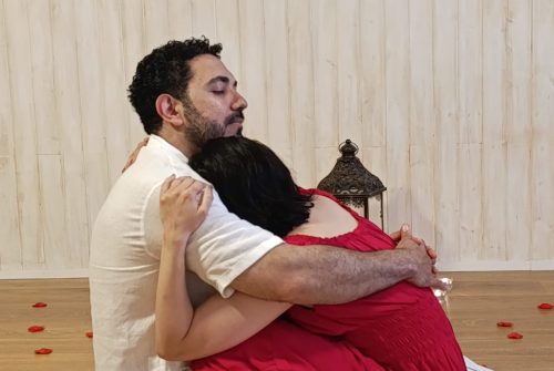 Red and white couple embrace